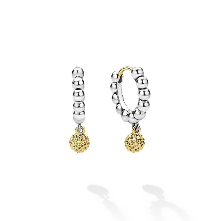 Sterling silver huggie earrings with gold accents.