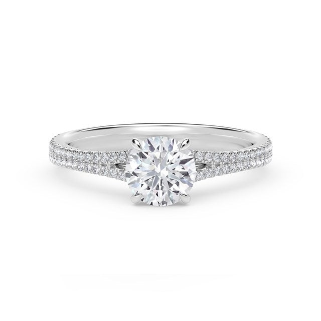 Platinum ring with round diamond and side stones.