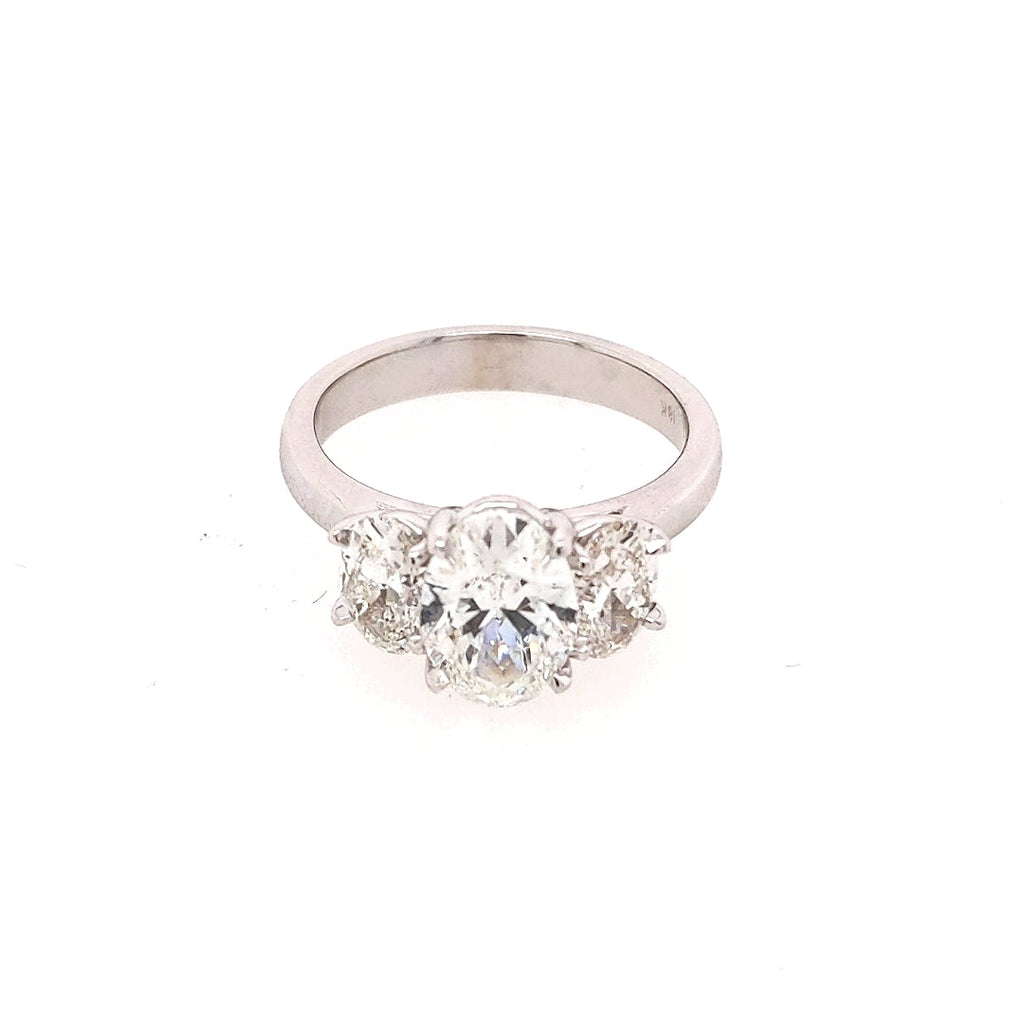 Oval diamond three-stone ring in white gold.