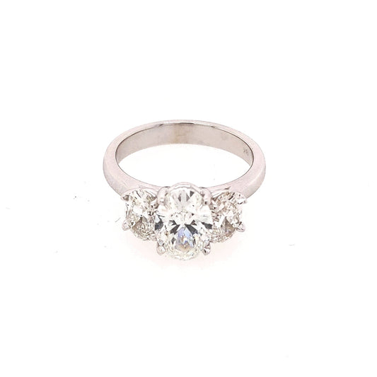 Oval diamond three-stone ring in white gold.
