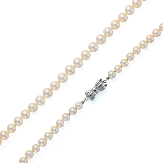 Cream freshwater pearl strand, sterling silver clasp.