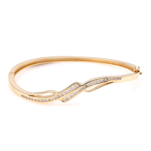 Wavy diamond yellow gold bracelet design.