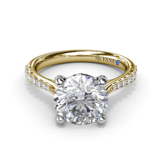 Dual-tone gold diamond solitaire engagement ring.