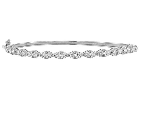 Flexible bangle with round diamonds in white gold.