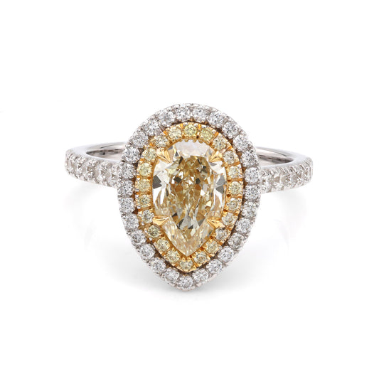 Pear-shaped yellow diamond halo engagement ring.