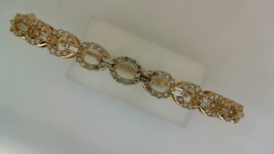 Yellow gold bangle with various shaped diamonds.