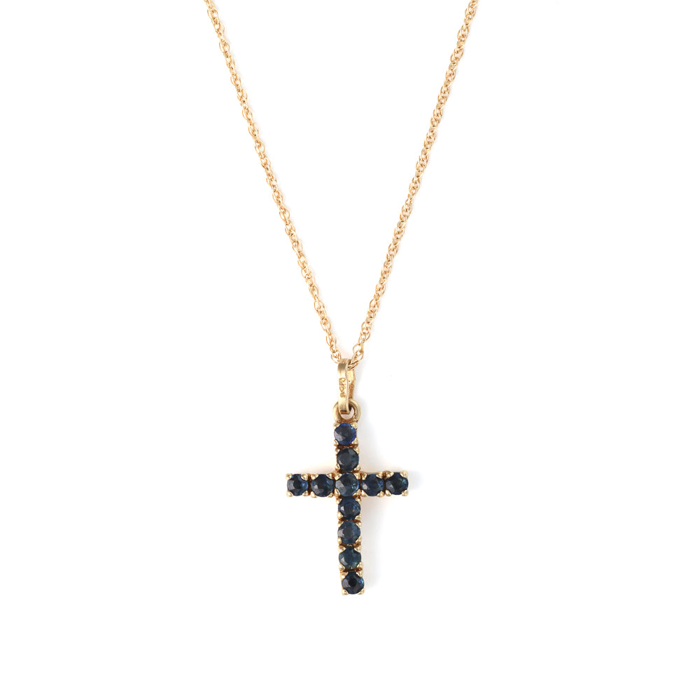 Yellow gold cross necklace with blue sapphires.