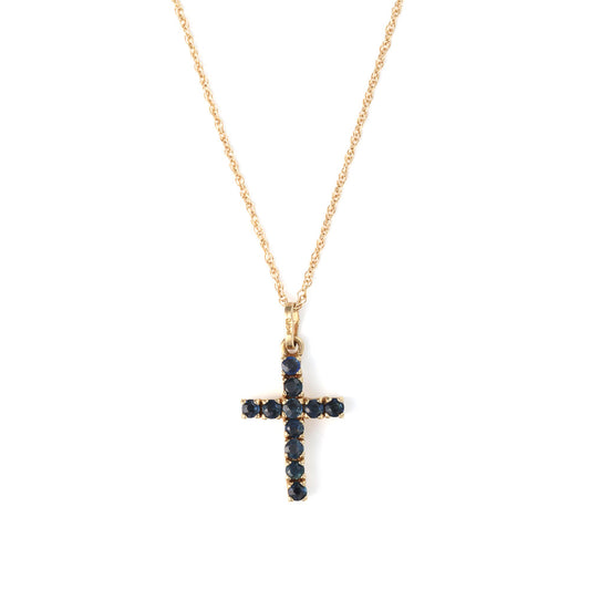 Yellow gold cross necklace with blue sapphires.