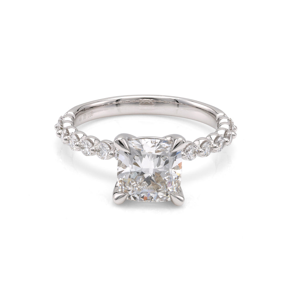 Cushion diamond ring with round accents.