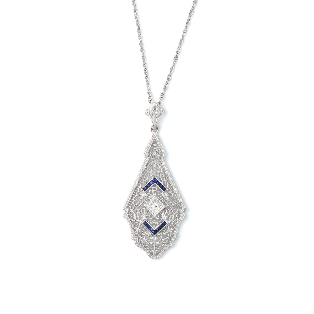 14K white gold necklace with princess-cut blue sapphires.