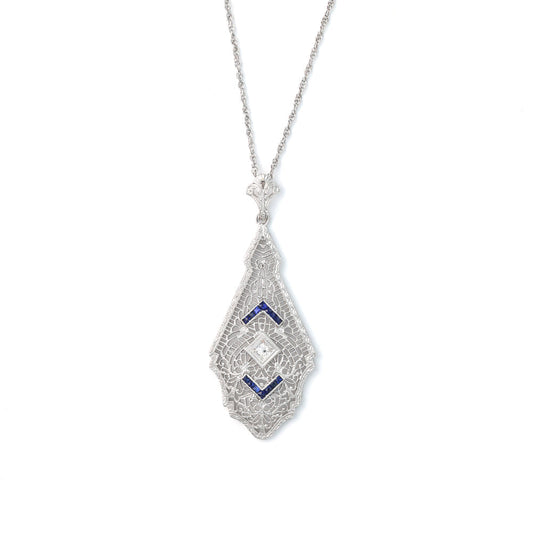 14K white gold necklace with princess-cut blue sapphires.