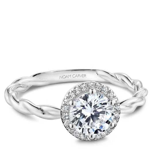 Halo diamond ring with twisted white gold band.