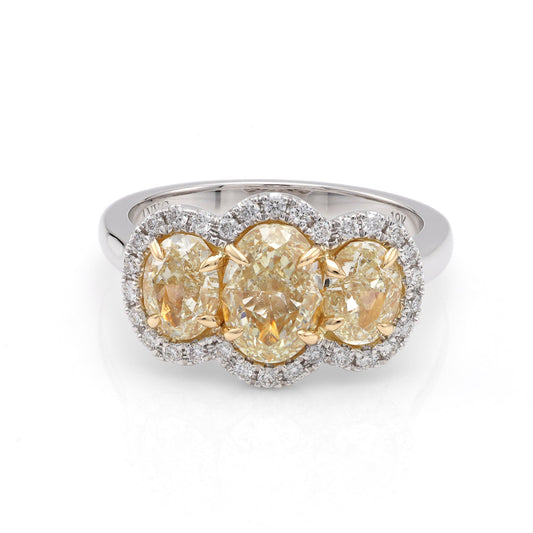 Oval yellow diamond halo engagement ring.
