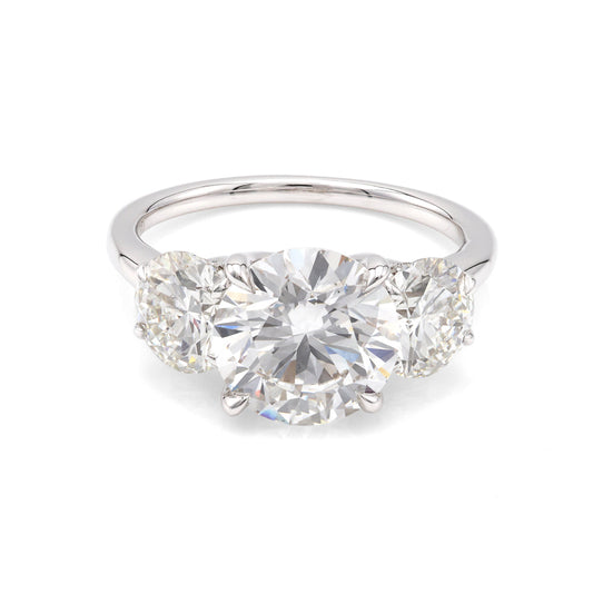 Three-stone white gold diamond engagement ring.