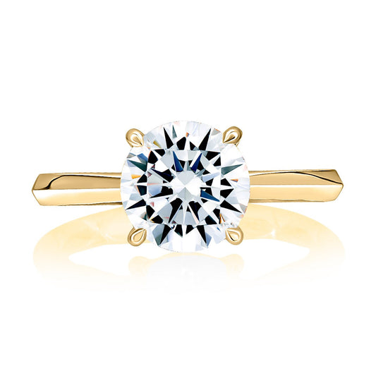 Yellow gold ring with round diamond centerpiece.