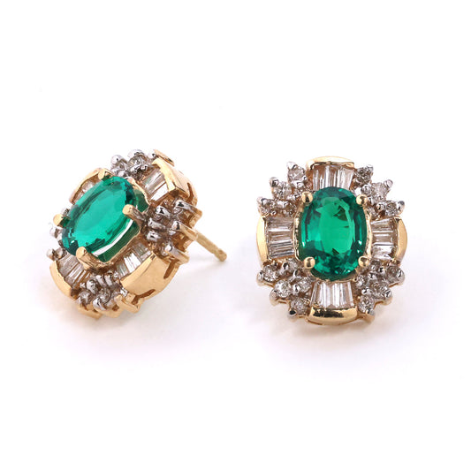 Oval emerald stud earrings with diamonds.