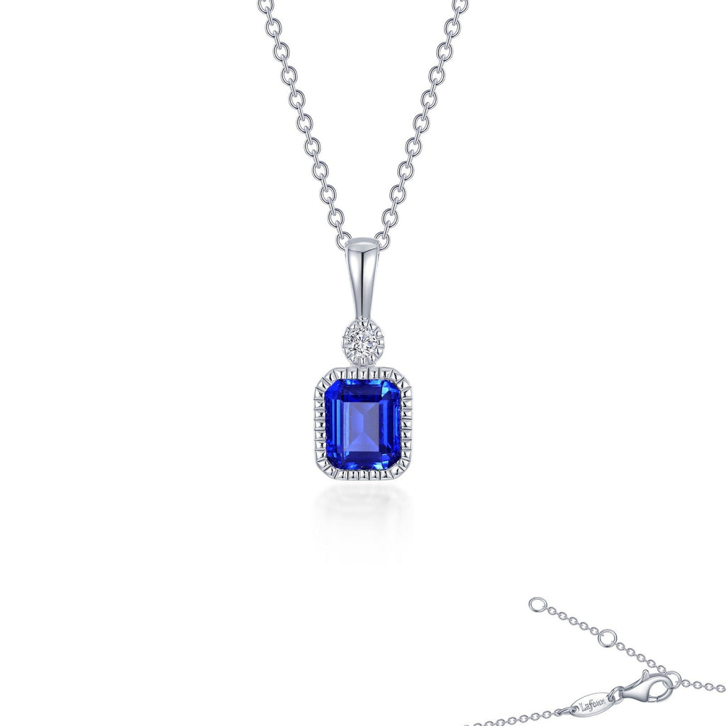 Simulated sapphire pendant with diamond accent.