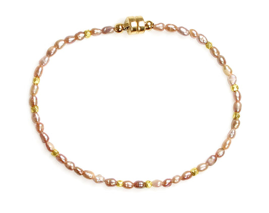 Pink pearl bracelet with yellow accents.