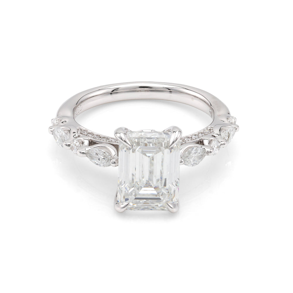 Emerald-cut diamond ring with side stones.