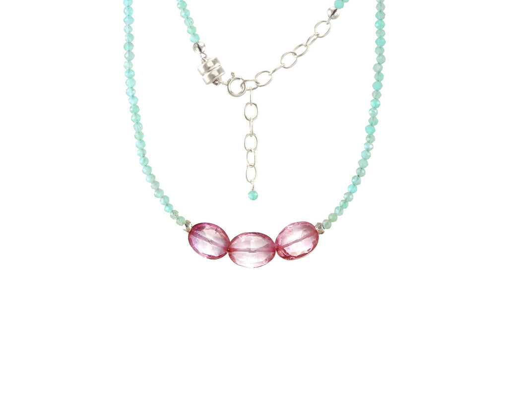 Turquoise bead necklace with pink gemstones.