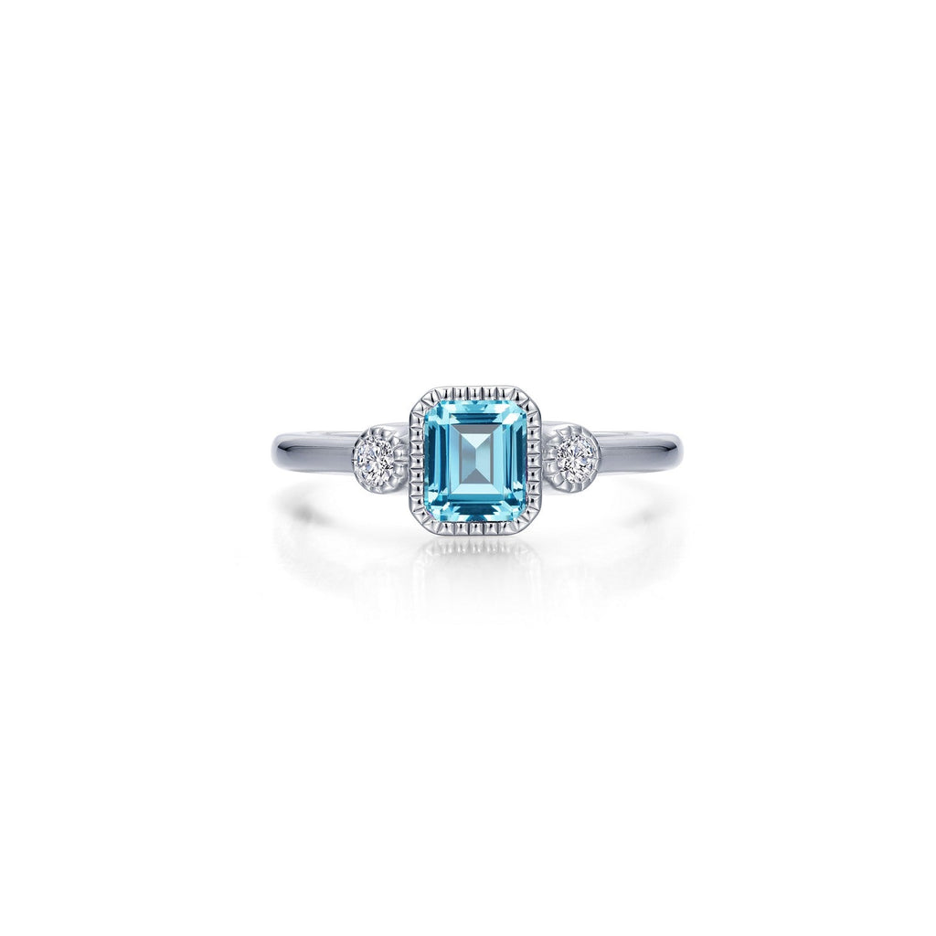 Emerald-cut aquamarine ring with diamond accents.