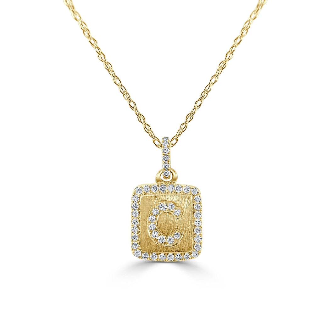 Gold necklace with diamond-accented initial pendant.