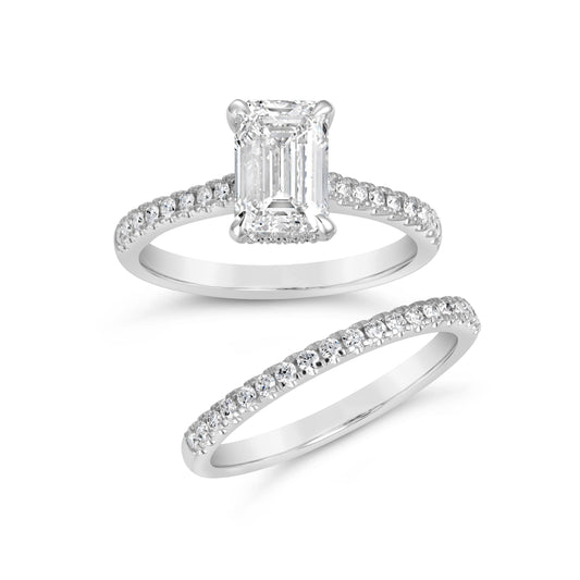 Emerald-cut diamond ring with round accents.