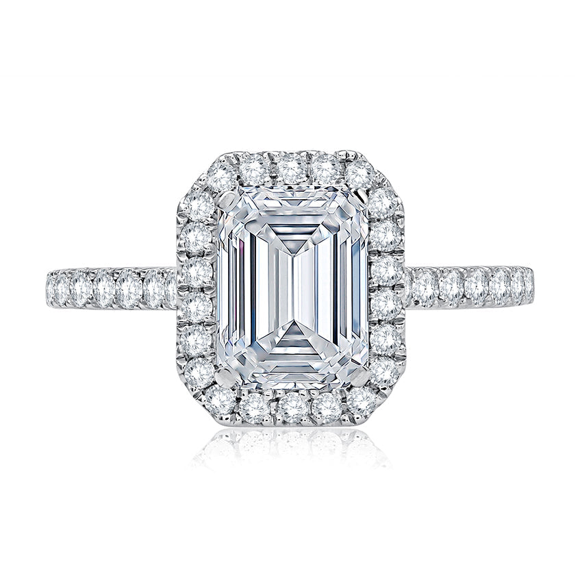 Halo diamond ring, white gold, emerald-cut setting.