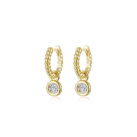 Gold twisted huggie earrings with round diamonds.