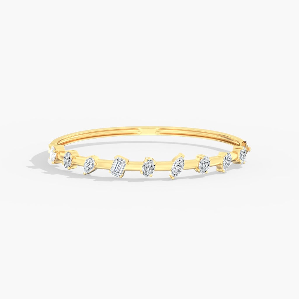 Yellow gold bangle with lab-grown diamonds.