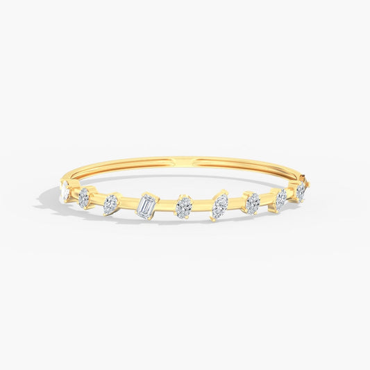 Lab-grown diamond yellow gold bangle bracelet.