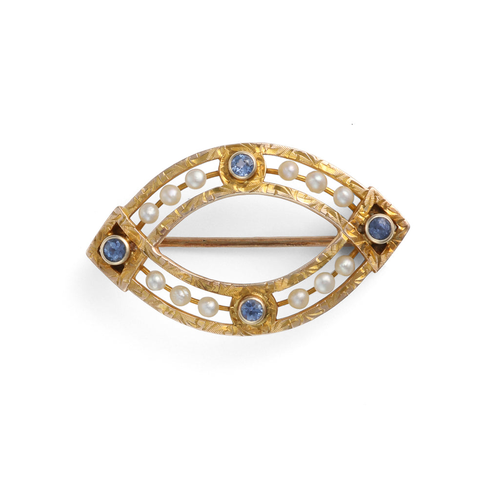 Eye-shaped gold pin with pearls, sapphires.