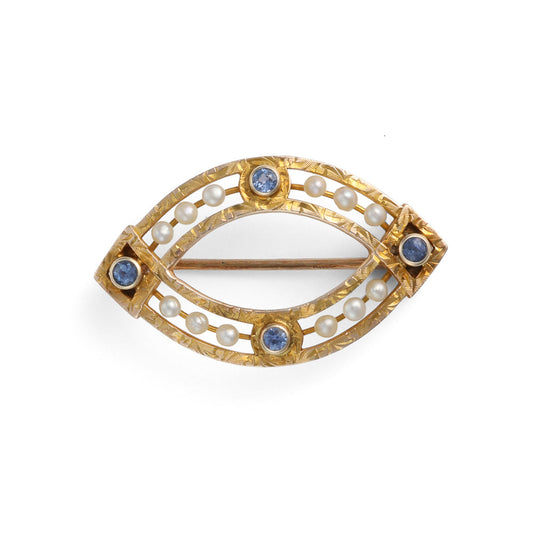 Eye-shaped gold pin with pearls, sapphires.