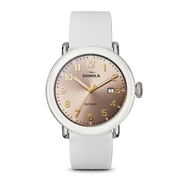 Rose dial, white rubber band, stainless steel case.