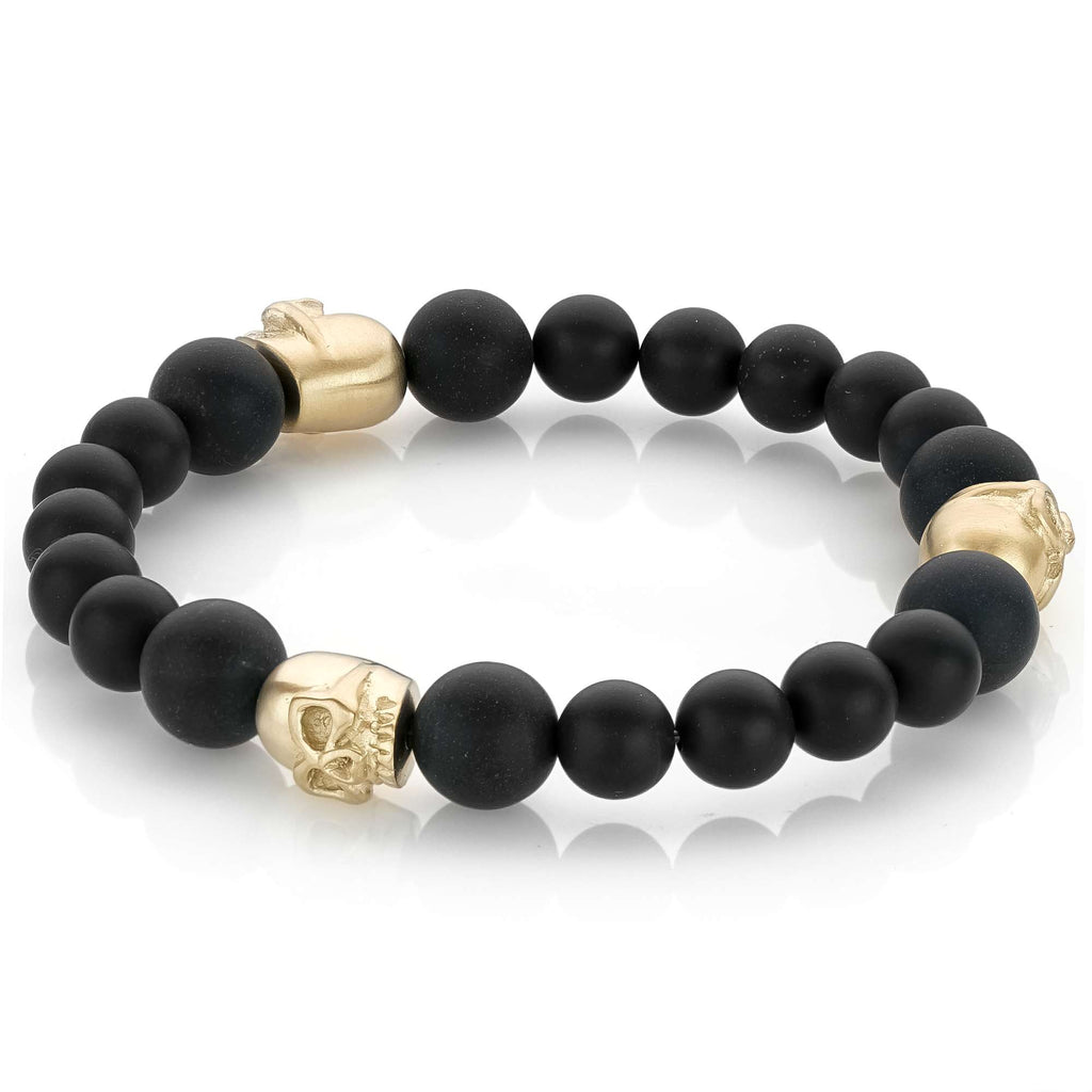 Black onyx bracelet with gold skull accents.