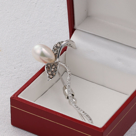 Diamond and pearl flower pin in box.