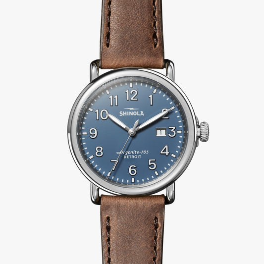 Blue dial, stainless steel case, leather strap.