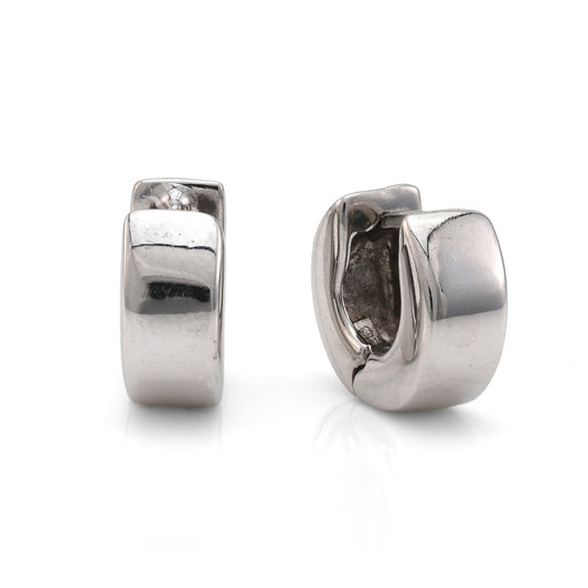 Polished white gold huggie earrings, hinge closure.