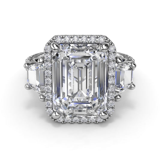 Halo three-stone diamond ring in white gold.