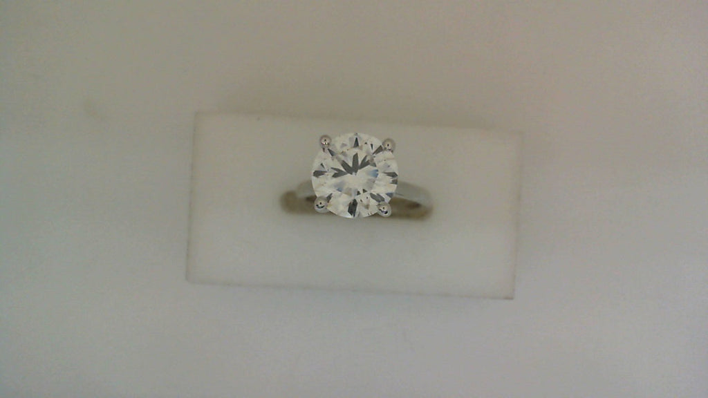 Round lab-grown diamond on white gold band.