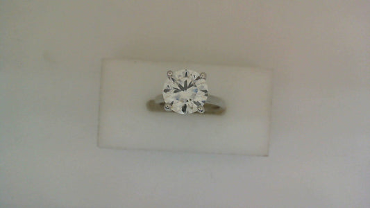 Round lab-grown diamond on white gold band.