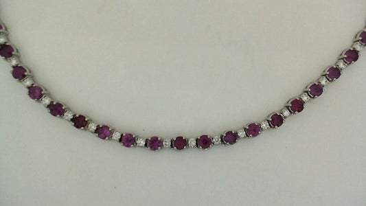 Ruby and diamond tennis necklace in white gold.