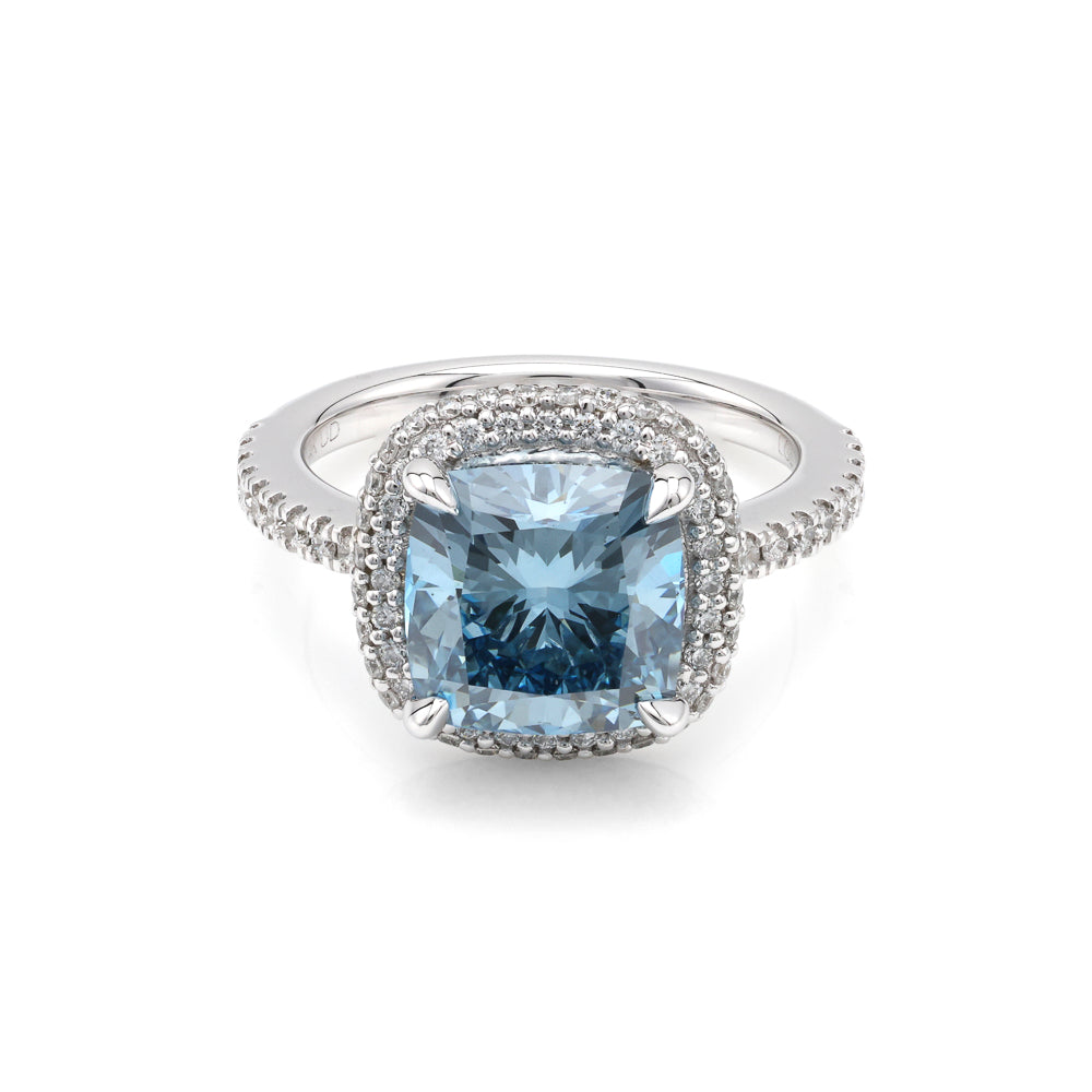 Blue diamond halo engagement ring in white gold.
