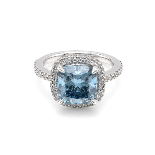 Blue diamond halo engagement ring in white gold.