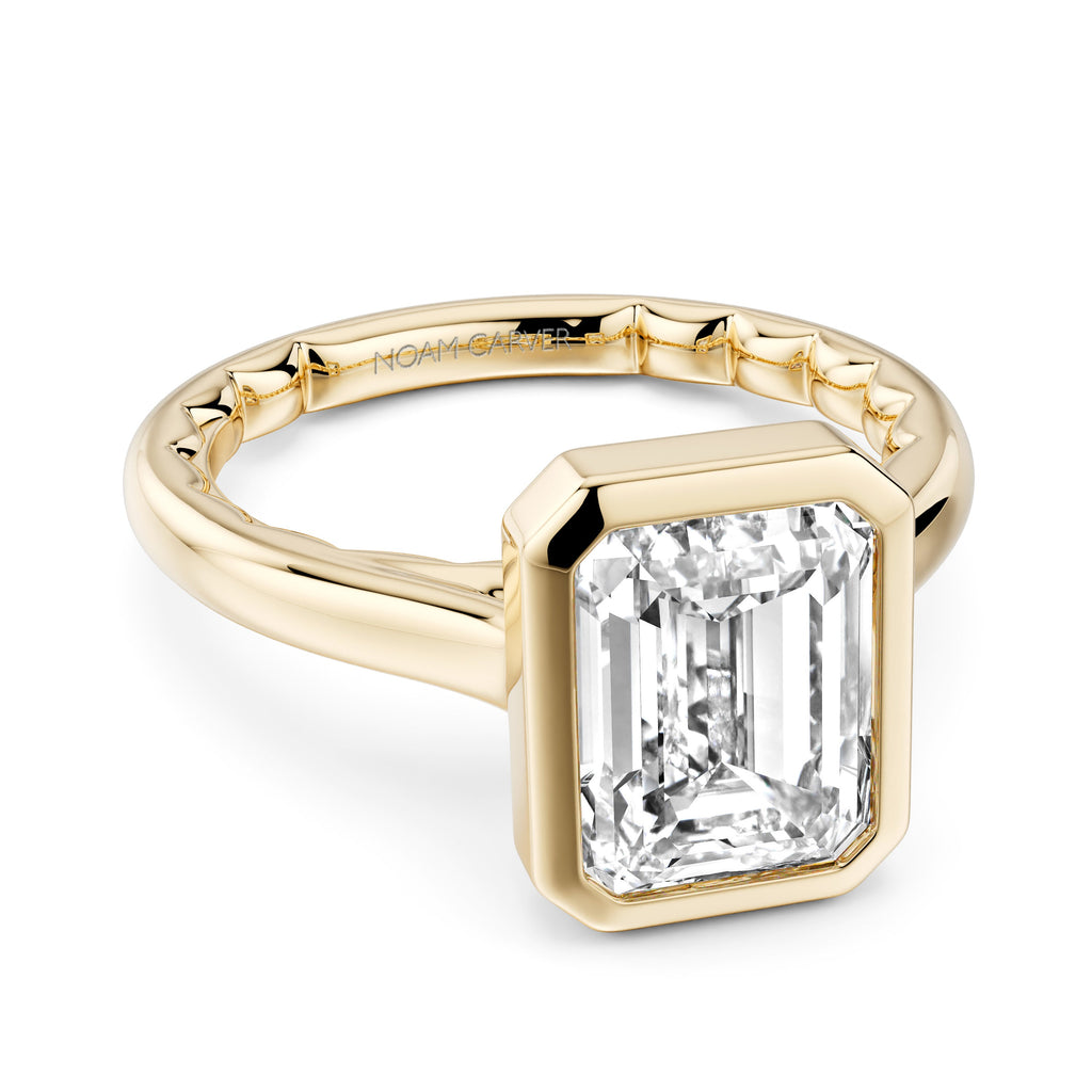 Yellow gold ring with emerald-cut diamond.