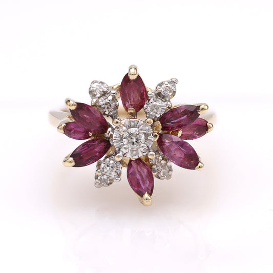 Marquise rubies and diamonds in gold ring.