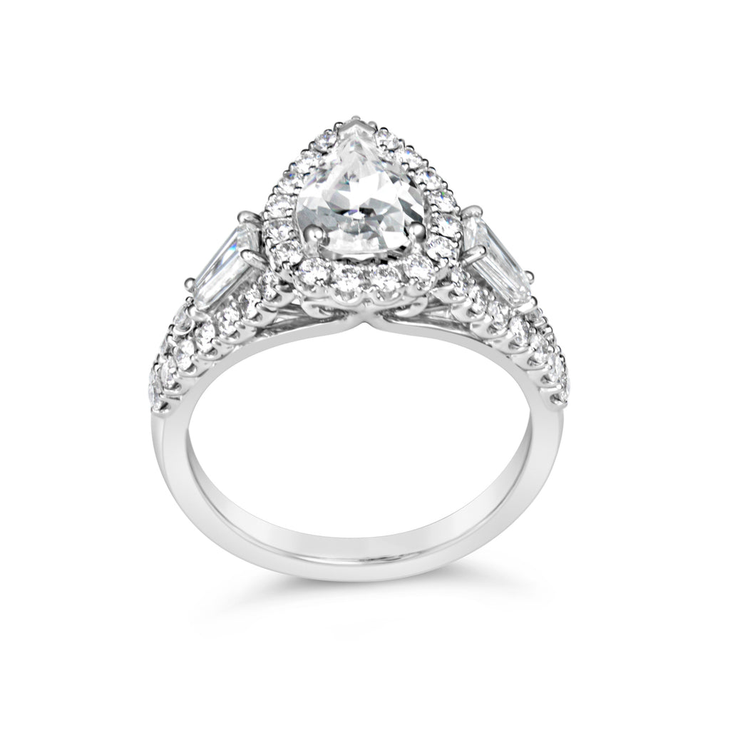 Halo diamond ring with baguette accents.