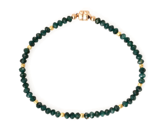 Grandidierite bead bracelet with gold accents.