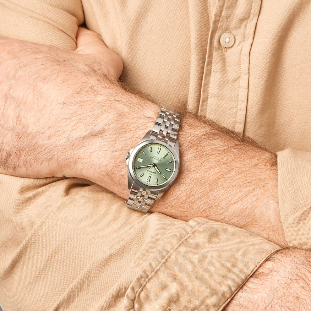 Stainless steel watch with green dial.