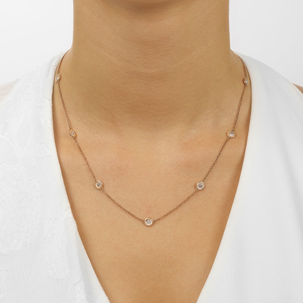 Rose gold necklace with round diamonds.